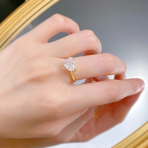 Macro shot of an S925 silver heart ring with large carbon diamond shown in mirror reflection