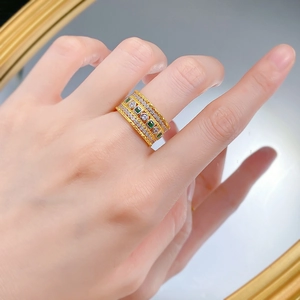 Vintage gold layered ring with square emeralds and pave diamonds on model's hand