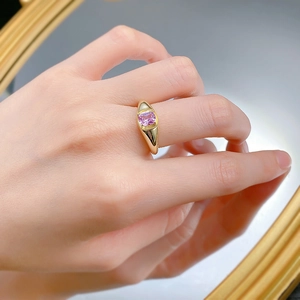 Close-up of a gold S925 silver signet ring with a rectangular pink sapphire gemstone
