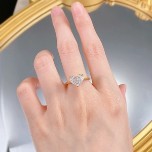 Close-up of 10x8mm heart-cut carbon diamond ring with three-prong gold setting