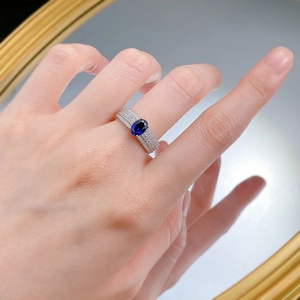Détail de bague en argent S925 avec pierre bleue ovale et sertissage micro-pave