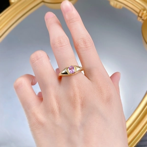Detailed view of an S925 silver ring with a rectangular pink gemstone on a gold band