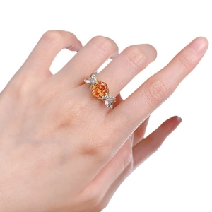 S925 silver ring with 7x9mm oval sunset orange stone and diamond accents on finger