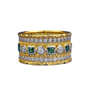 Vintage layered mixed-metal ring featuring emerald-cut green gems and zircon rows