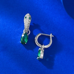 Macro detail of S925 sterling silver stamp on earrings with green oval gemstone