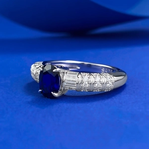 Elegant 925 sterling silver ring with oval royal blue gemstone and side diamonds