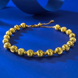 Detailed shot of laser-brushed gold beads and polished spheres on a S925 silver bracelet