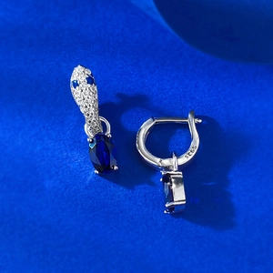 Detailed close-up of S925 sterling silver snake earrings with oval blue gemstones