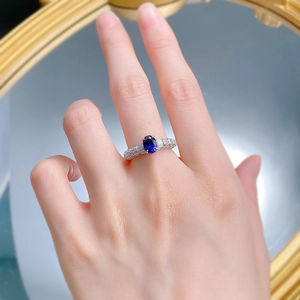 Detailed macro of a 925 silver ring featuring a large oval royal blue sapphire gemstone