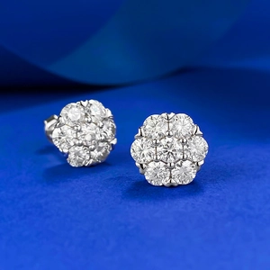 Elegant S925 sterling silver moissanite flower stud earrings on blue silk background