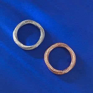Detail of silver and rose gold S925 sterling silver rings with twisted pavé zircon stones