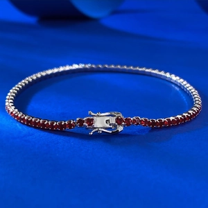 Detail of red cubic zirconia tennis bracelet with silver plating and secure clasp