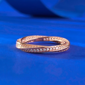 Close-up of S925 sterling silver rose gold twist ring with full micro-pave diamond setting
