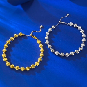 Detail of silver and gold beaded bracelets with polished finish and lobster clasp closures