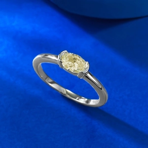 Elegant S925 sterling silver ring featuring an oval yellow gemstone on a blue surface