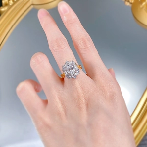 Detailed view of luxury oval cluster ring with sparkling crystals on model's finger