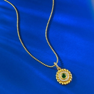 Elegant gold beaded necklace with a vintage round emerald pendant and zircon halo decoration