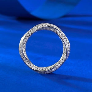 Detail of twisted Mobius ring in S925 silver with full diamond-set zircon inlay