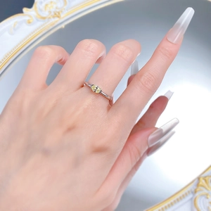 Close-up of S925 silver ring featuring an oval yellow diamond on a model hand