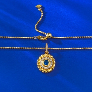 Macro view of S925 sterling silver beaded chain with a round blue sapphire pendant