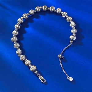 Detailed macro view of S925 sterling silver beaded bracelet with laser-brushed texture beads