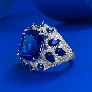 Luxurious 925 silver ring featuring a large cushion cut blue corundum with pave diamond accents