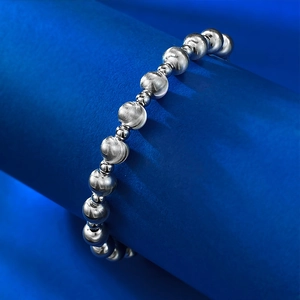 Macro view of S925 sterling silver beaded bracelet with brushed and polished texture