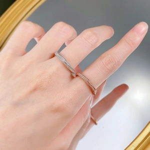 Detail of silver and rose gold S925 sterling silver diamond rings with mirror reflection