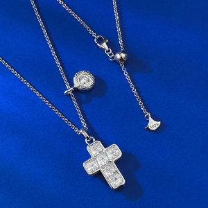 Macro detail of S925 sterling silver cross pendant with sparkling carbon diamonds