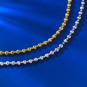 Detail of S925 sterling silver and gold beads with laser brushed cat-eye finish