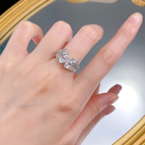 Detailed view of S925 silver ring with crystal butterfly and pavé setting on a mirror