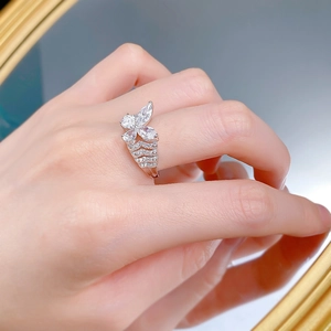 Detail of layered S925 silver butterfly ring with pear-cut zirconias worn on hand
