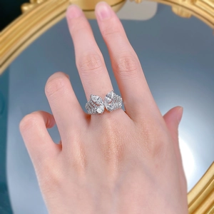 Detailed close-up of a layered S925 silver butterfly ring with sparkling pear-cut crystals