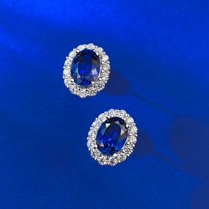 Elegant 925 silver stud earrings featuring oval blue sapphire and sparkling diamond halo