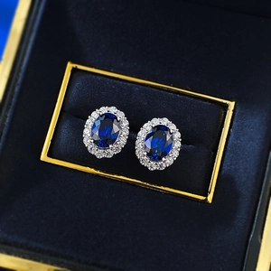 Classic S925 silver oval blue corundum stud earrings with halo cubic zirconia accents