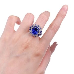 Elegant 925 sterling silver ring with large rectangular blue sapphire and halo setting