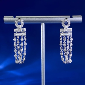 Macro detail of silver long tassel earrings with sparkling zircon for evening wear