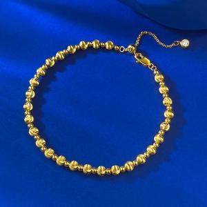 Detail of S925 silver beaded bracelet with brushed golden finish and lobster clasp