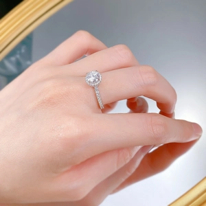 Close-up of S925 silver halo ring with one carat round diamond on a model's finger