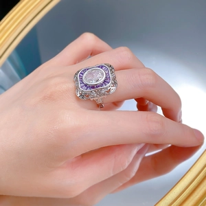 Detail of S925 silver ring featuring an oval clear gem and purple trapezoid accents