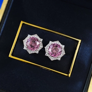 Close-up of 8mm rose purple millennium cut stone earrings in a blue velvet box