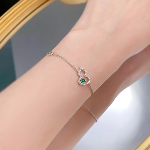 Detailed view of S925 silver gourd bracelet with white zircon and green gemstone
