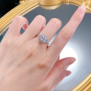 Detail of S925 silver halo ring with cushion cut center diamond on model hand