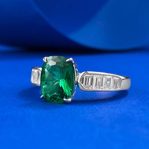 S925 silver ring featuring a large cushion cut green stone and baguette side gems