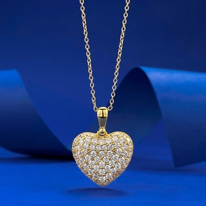 Luxurious gold-plated S925 silver heart pendant necklace with pavé-set zircons on blue background