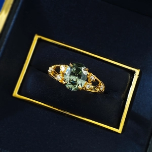 Detailed macro view of S925 silver ring with oval green tourmaline in velvet box