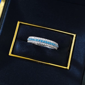 Macro shot of S925 silver Paraiba style multi-row band ring in a blue velvet jewelry box
