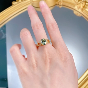 Detail of s925 silver ring with oval mint green gemstone and star-shaped hollow design