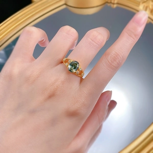 Detail view of S925 silver ring with oval mint green gemstone and star-shaped accents