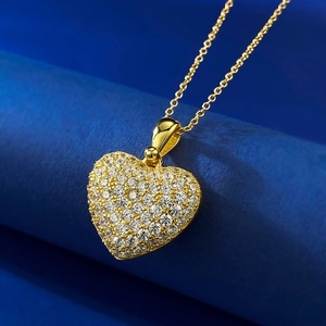 Macro shot of gold-plated S925 silver heart pendant with pavé cubic zirconia inlay
